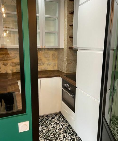 Cuisine en L avec meubles blancs et carrelage graphique